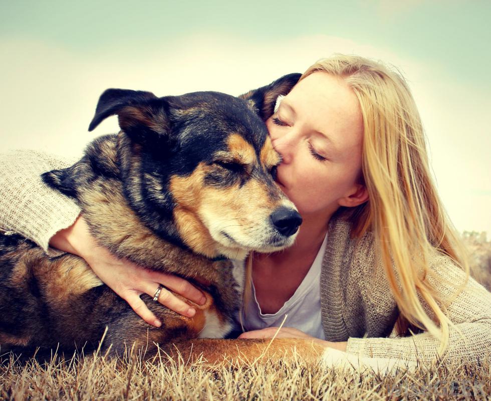 girl-kissing-old-dog-on-ground